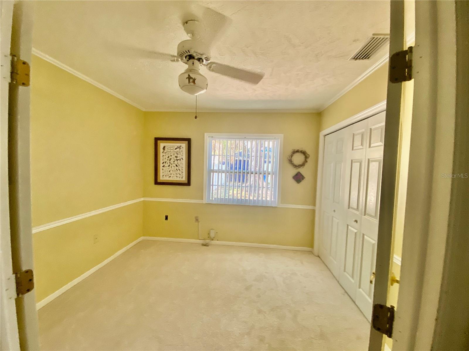 BEDROOM WITH CHAIR RAILING, CROWN MOLDING, AND FRENCH DOORS