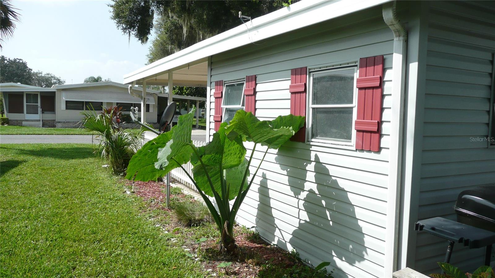 To the tastefully landscaped side