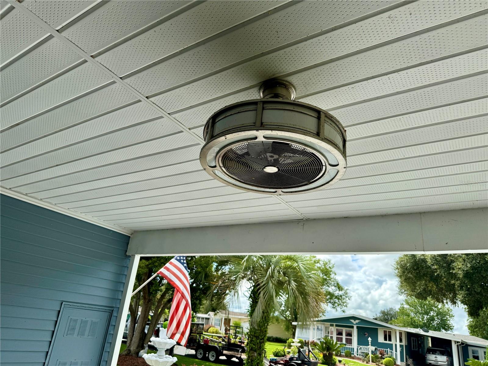 ONE OF TWO FANS IN CARPORT