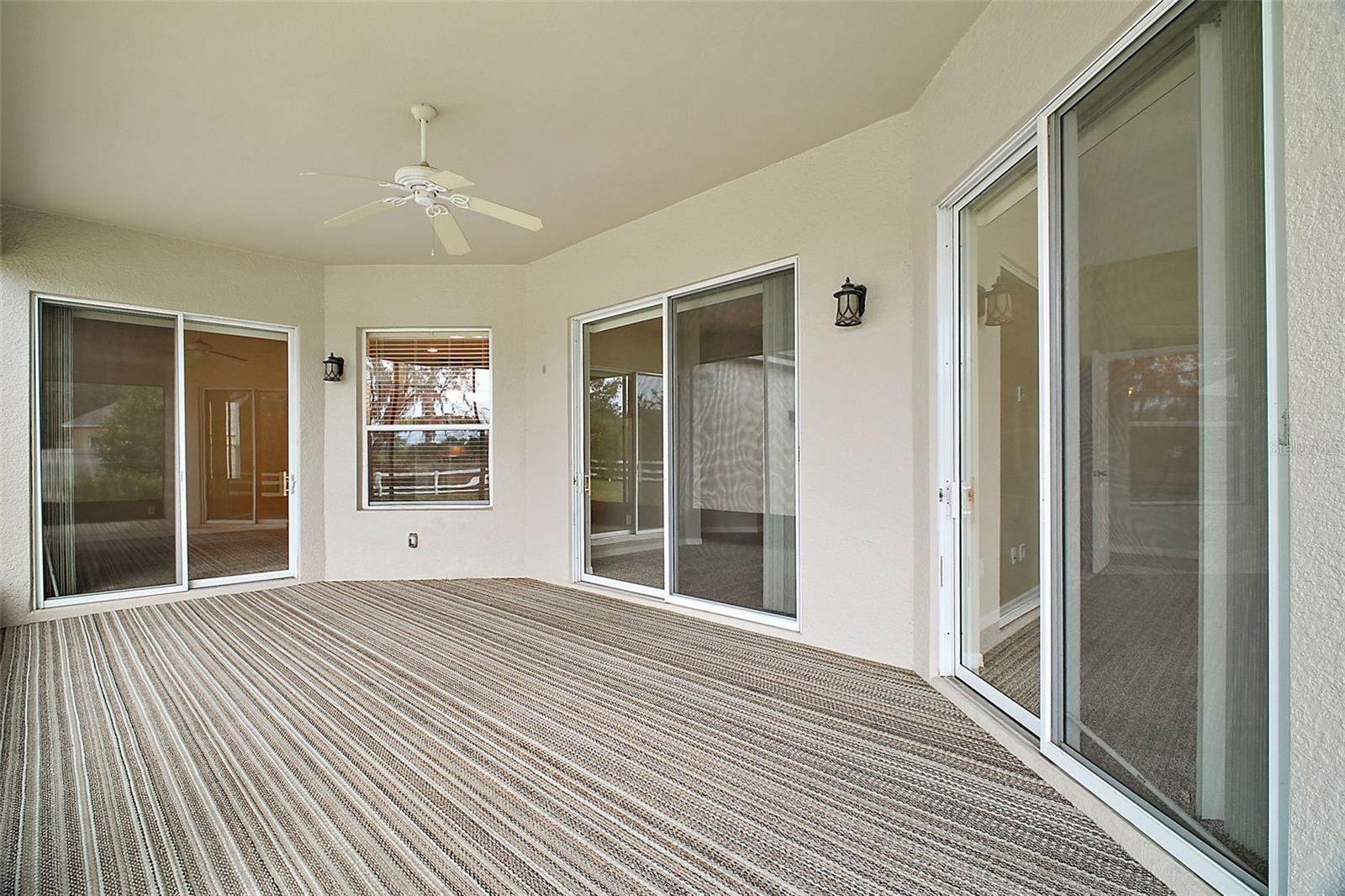 screened back porch- opens to primary bedroom, living, and family room with sliding doors