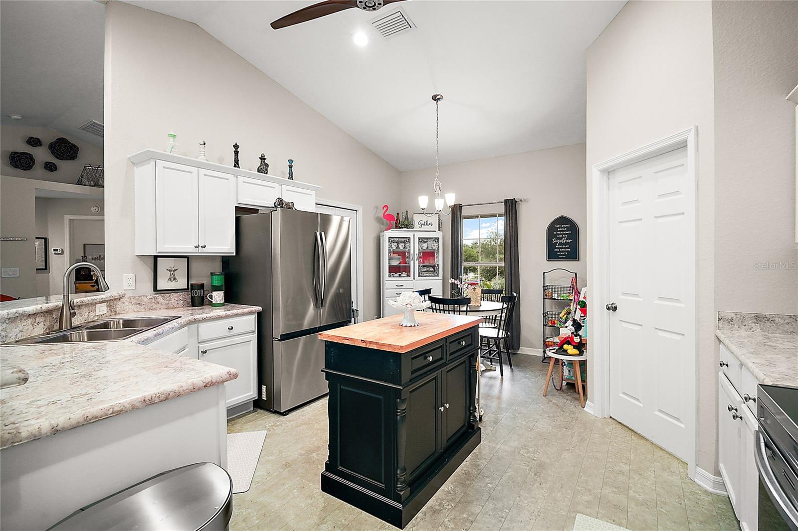 open kitchen with island and eat in dinette